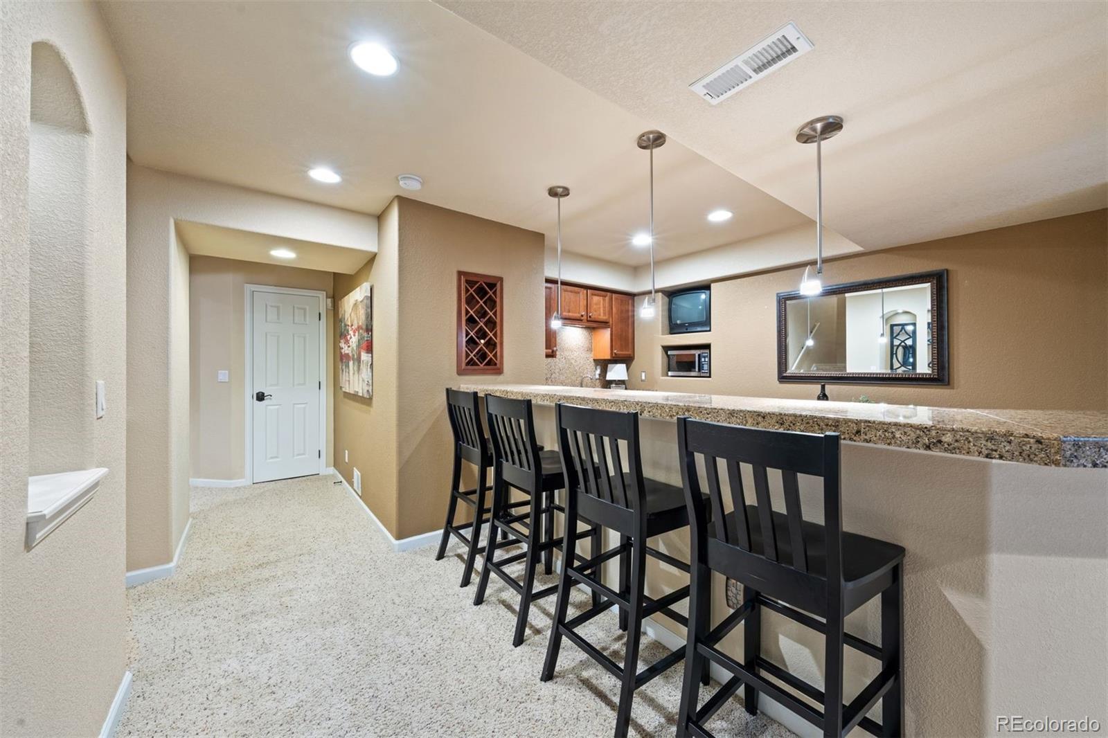 10289 South Dan Court Highlands Ranch, CO 80130 - Photo 30 of 36 a view of a a dining room with furniture window and wooden floor