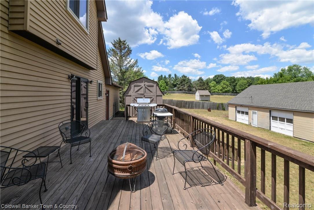 3210 Chase Lake Road Howell, MI 48855 - Photo 2 of 38 42' of tiered decking to enjoy outdoor entertaining!