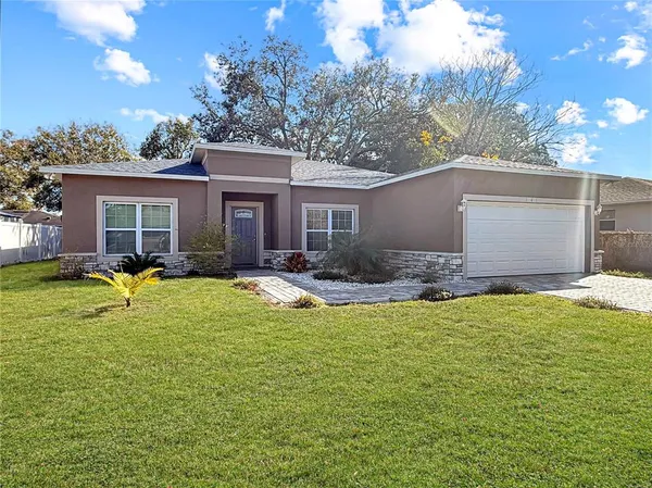 a view of a house with swimming pool and a yard