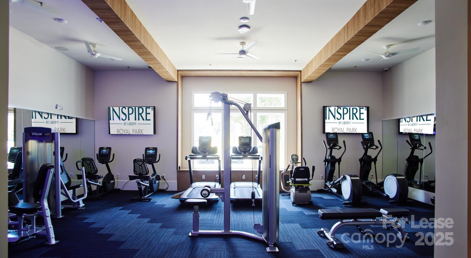 4101 Glenloch Circle, Unit B1 Matthews, NC 28105 - Photo 12 of 28 a view of a livingroom with furniture hardwood floor and gym equipment