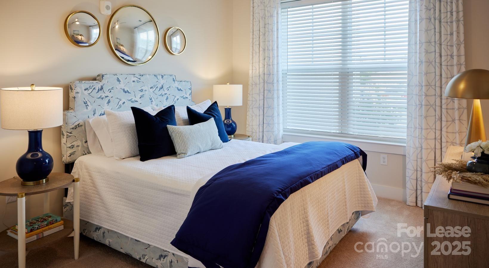 4101 Glenloch Circle, Unit B1 Matthews, NC 28105 - Photo 27 of 28 a bed sitting in a bedroom next to a window and a lamp