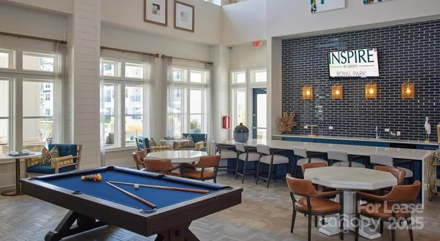 a living room with furniture a large window and dining table