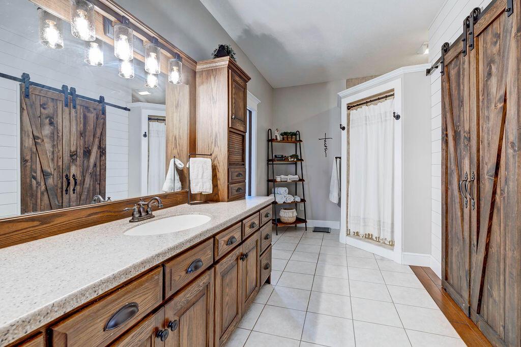 4045 Russell Road Mount Gilead, OH 43338 - Photo 27 of 74 • Ceramic tile flooring • Gray painted walls • Two walk-in closets • Body jet shower (plumbed for tub) • Amish custom cabinets • Lots of storage • Toilet room