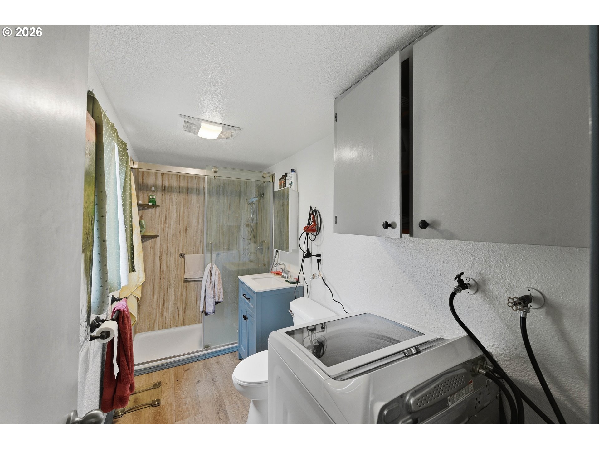 1955 Maple Street North Bend, OR 97459 - Photo 44 of 48 a bathroom with a sink a toilet a mirror and shower