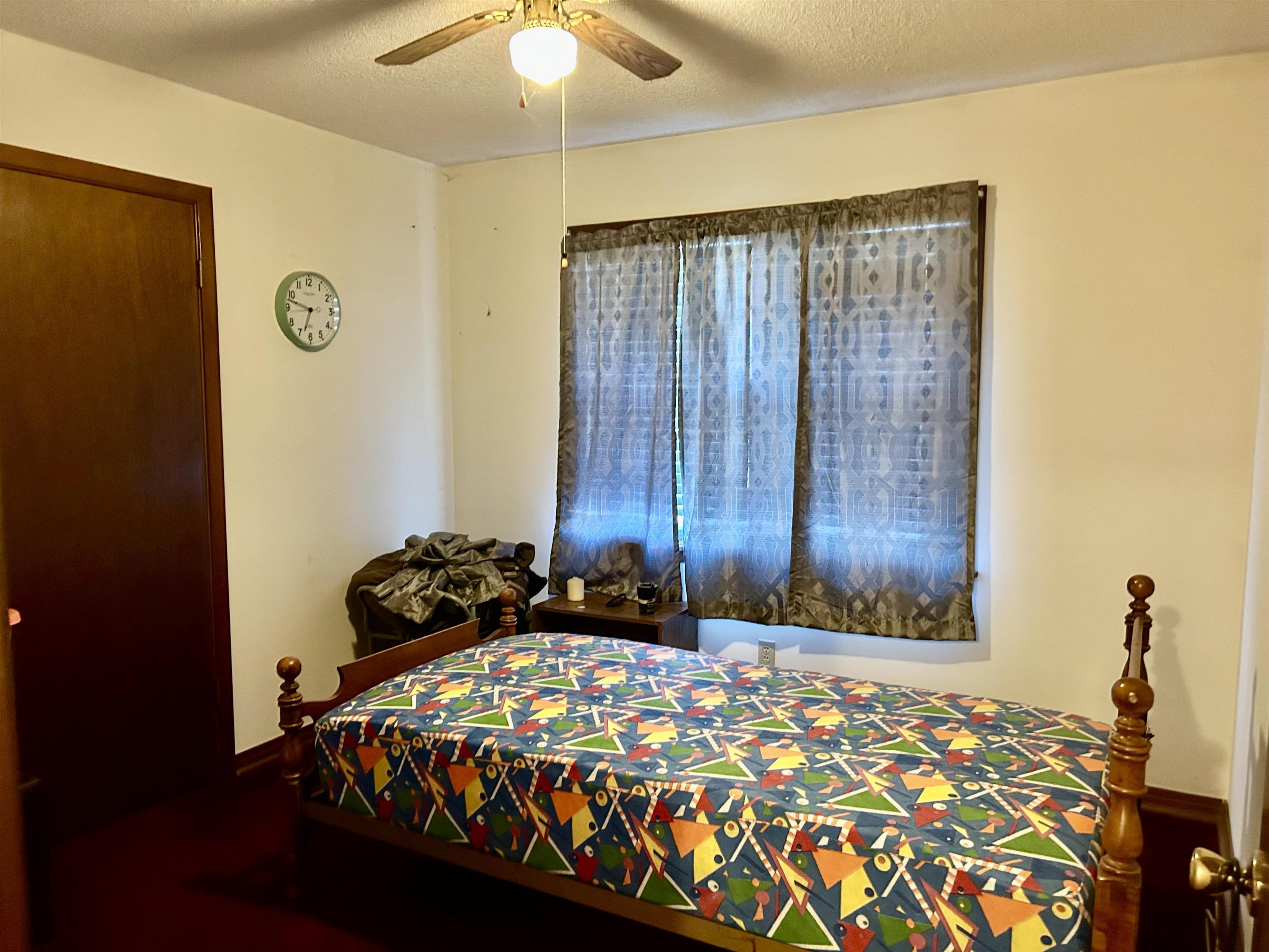 224 Mary Lynn Avenue Ripley, TN 38063 - Photo 13 of 16 a bedroom with a bed and a chandelier