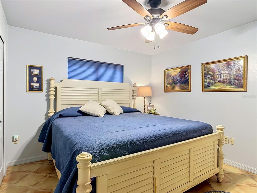 1395 Maytown Road Osteen, FL 32764 - Photo 34 of 65 a bedroom with a bed and a chandelier