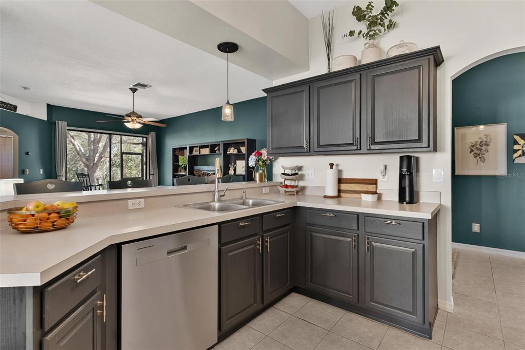 33142 Kaylee Way Leesburg, FL 34788 - Photo 18 of 45 a kitchen with stainless steel appliances granite countertop a sink a stove and a refrigerator