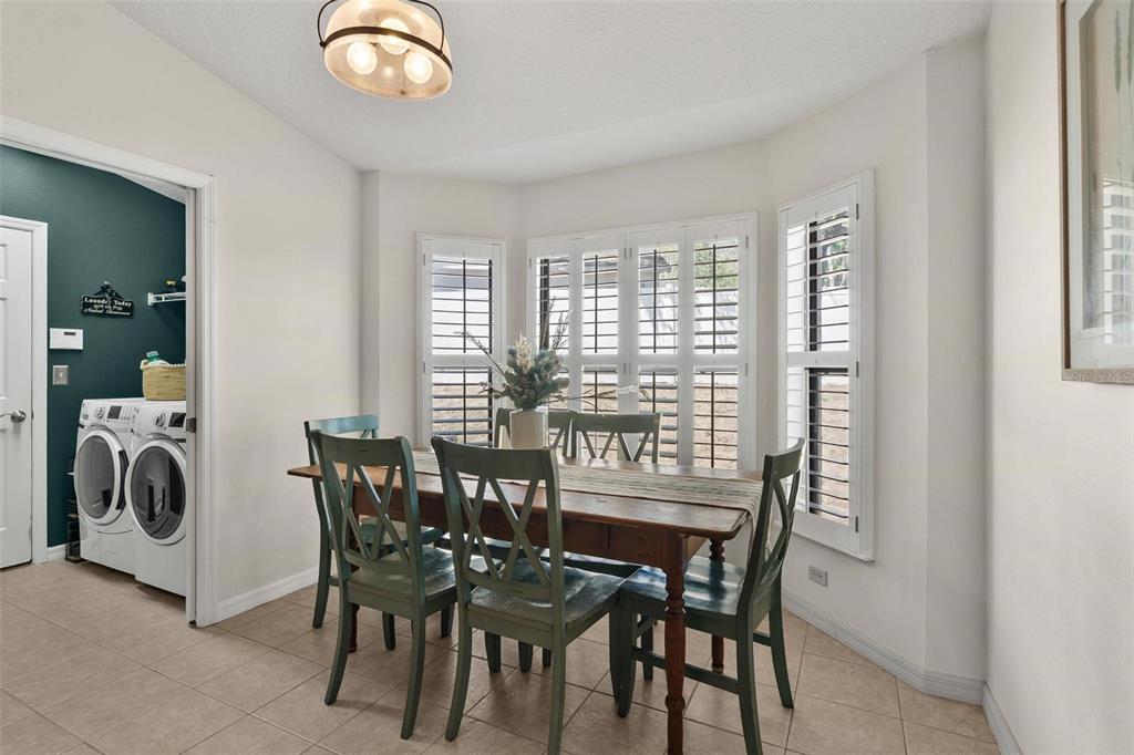 33142 Kaylee Way Leesburg, FL 34788 - Photo 21 of 45 a view of a dining room with furniture and chandelier