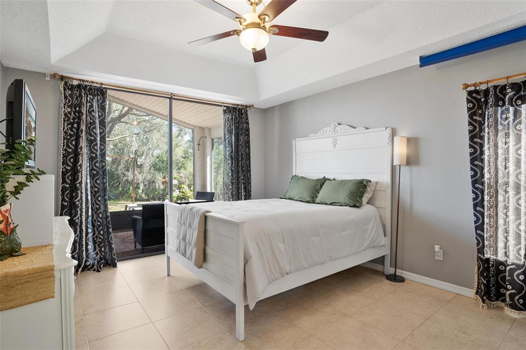 33142 Kaylee Way Leesburg, FL 34788 - Photo 23 of 45 a bedroom with a bed and a large window