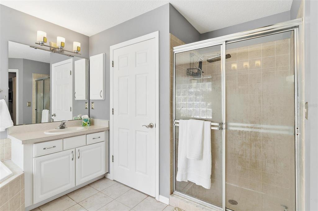33142 Kaylee Way Leesburg, FL 34788 - Photo 26 of 45 a bathroom with a double vanity sink and mirror