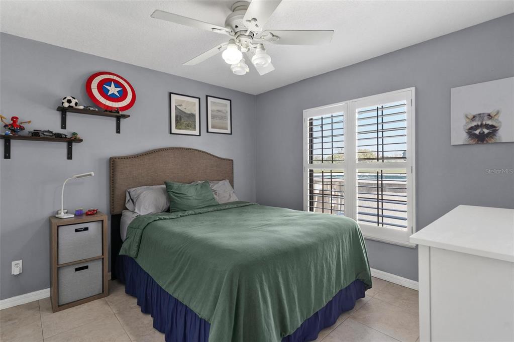 33142 Kaylee Way Leesburg, FL 34788 - Photo 29 of 45 a bedroom with a bed and a table