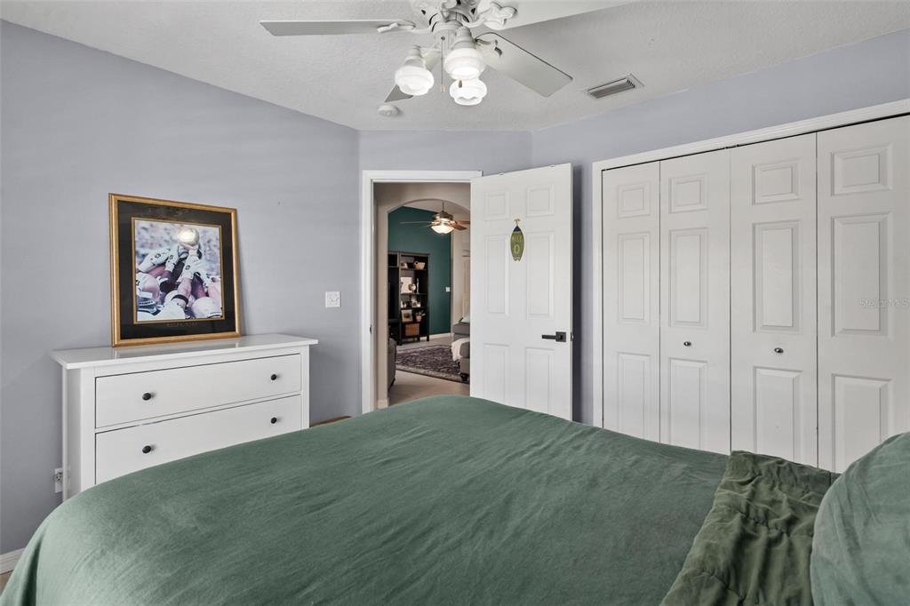 33142 Kaylee Way Leesburg, FL 34788 - Photo 30 of 45 a bedroom with a bed and a dresser