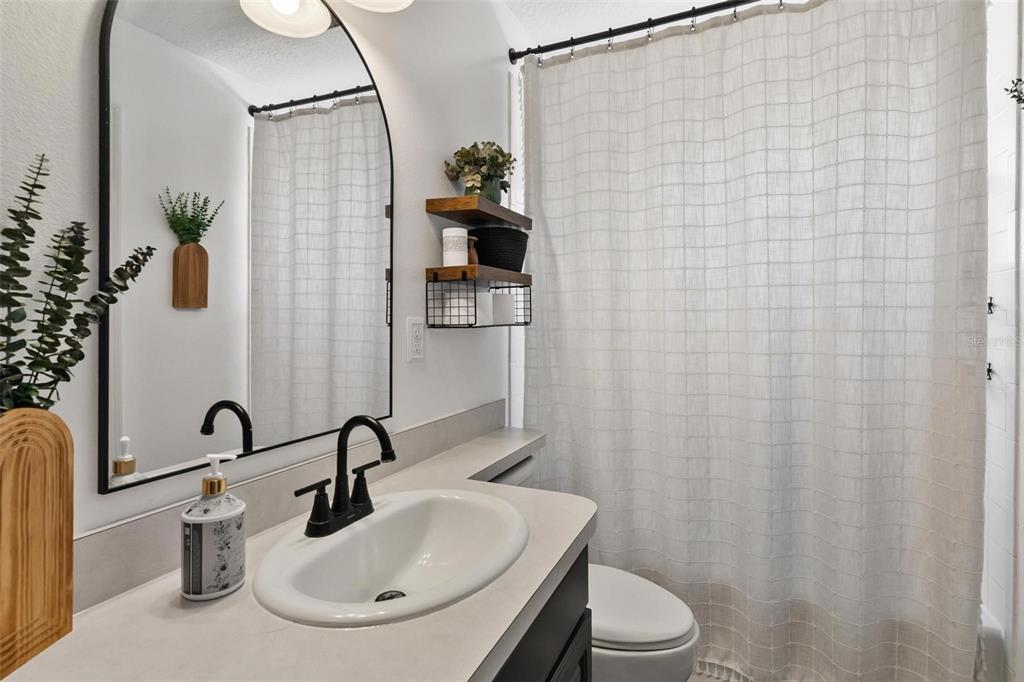 33142 Kaylee Way Leesburg, FL 34788 - Photo 31 of 45 a bathroom with a sink and a mirror