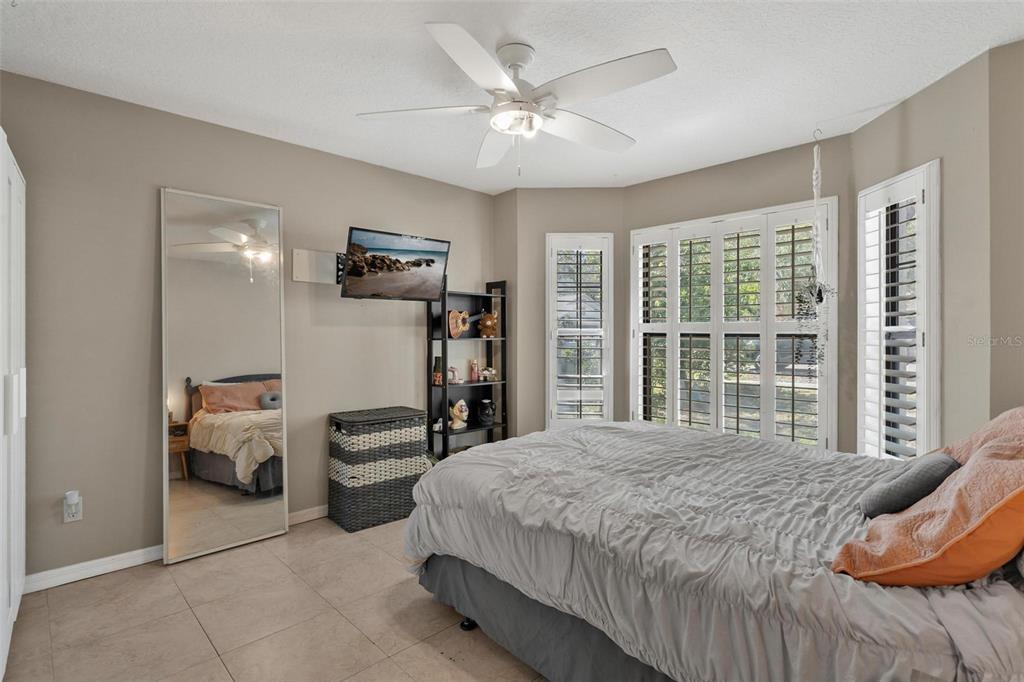 33142 Kaylee Way Leesburg, FL 34788 - Photo 34 of 45 a bedroom with a bed and a large window