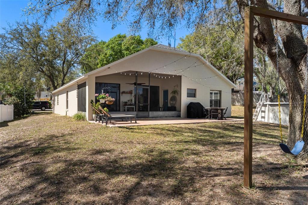 33142 Kaylee Way Leesburg, FL 34788 - Photo 38 of 45 a view of a house with backyard and a tree
