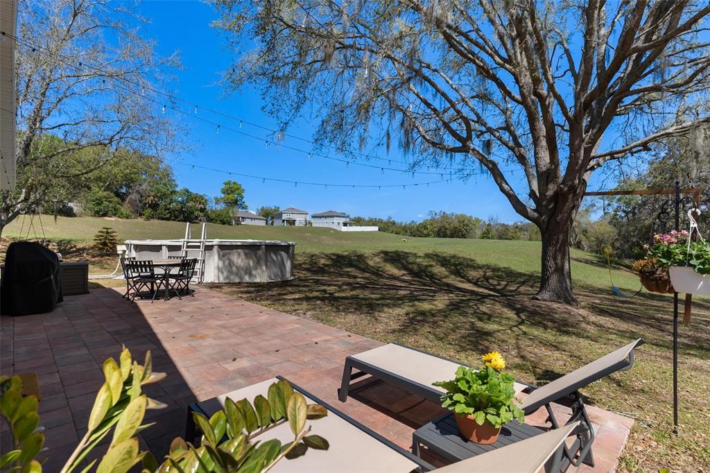 33142 Kaylee Way Leesburg, FL 34788 - Photo 4 of 45 a view of a terrace with chairs and a fire pit