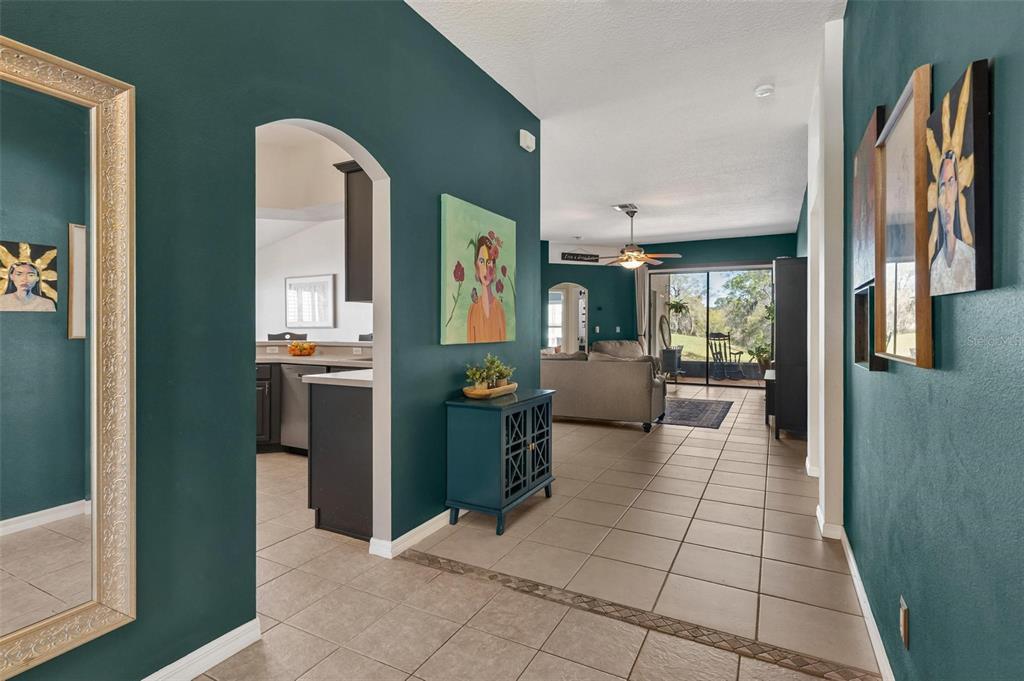 33142 Kaylee Way Leesburg, FL 34788 - Photo 10 of 45 a lobby with furniture and a mirror