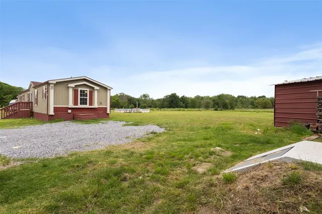 a view of a house with a yard and a garden