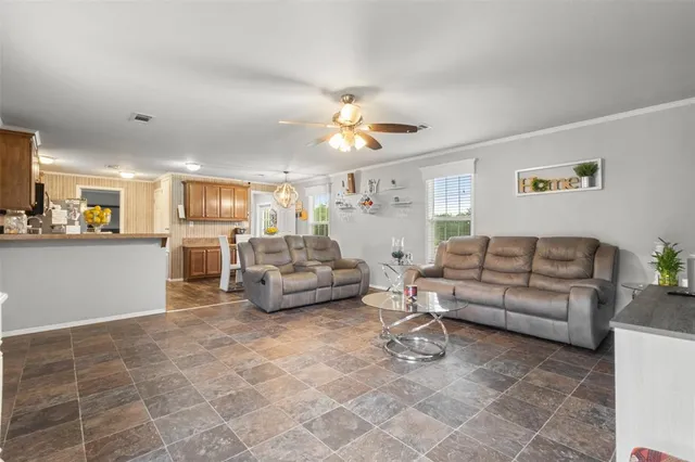 a living room with furniture and a kitchen view