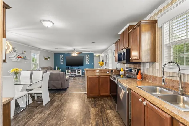 a kitchen with counter top space a sink appliances and cabinets