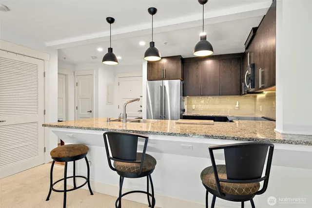 a kitchen with a sink cabinets and stainless steel appliances