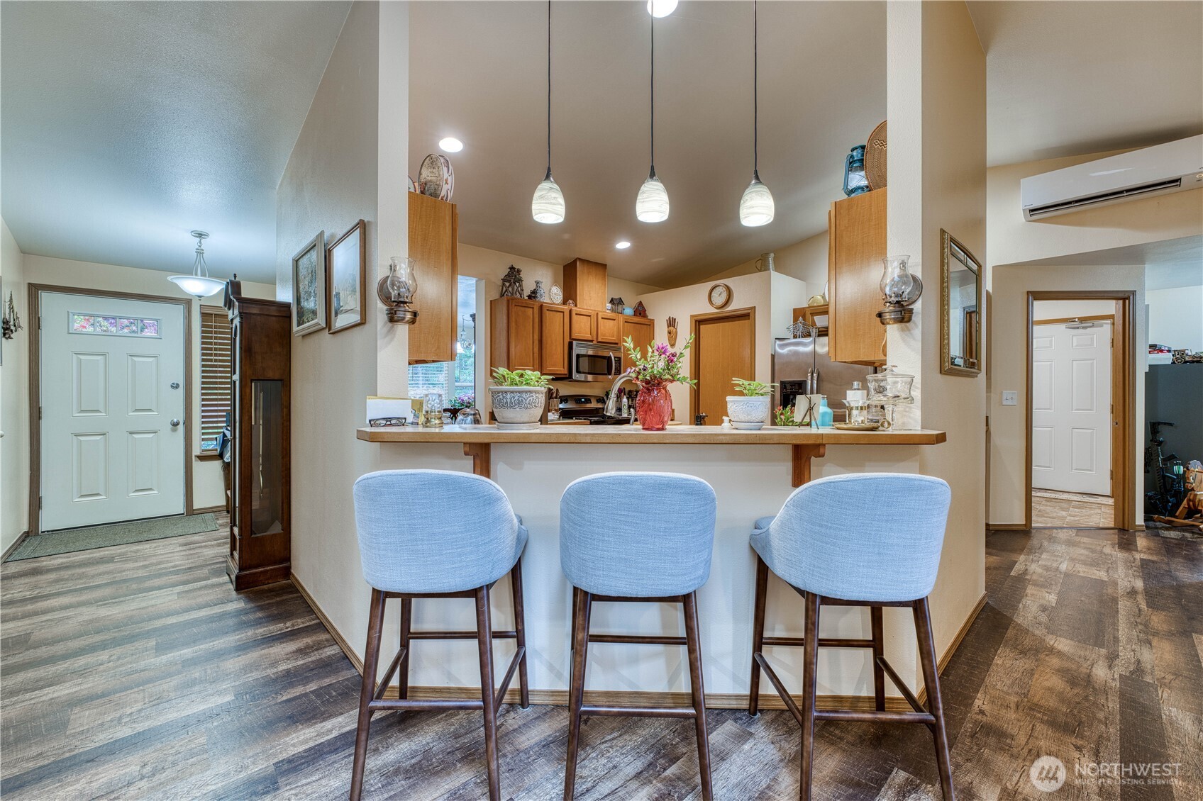 991 Northeast Hurd Road Belfair, WA 98528 - Photo 17 of 40 a kitchen with stainless steel appliances granite countertop a dining table chairs and wooden floor