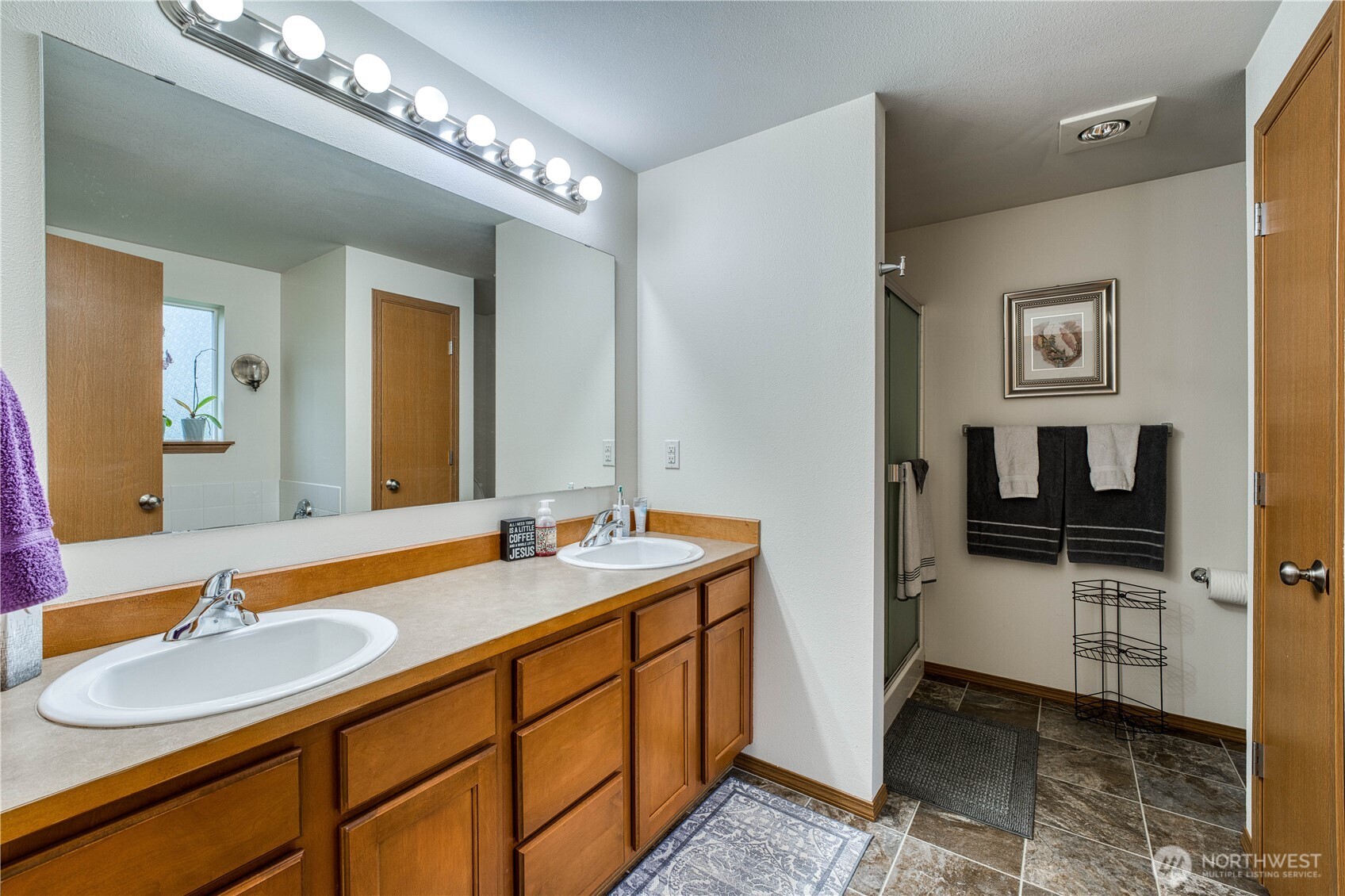 991 Northeast Hurd Road Belfair, WA 98528 - Photo 24 of 40 a en suite bathroom with a sink and a mirror