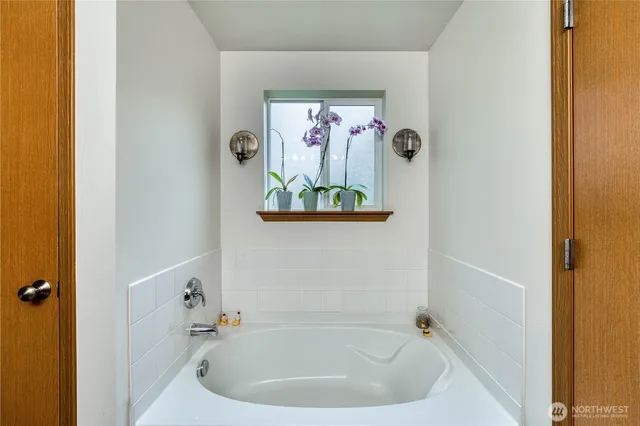a bath tub sitting next to a white sink
