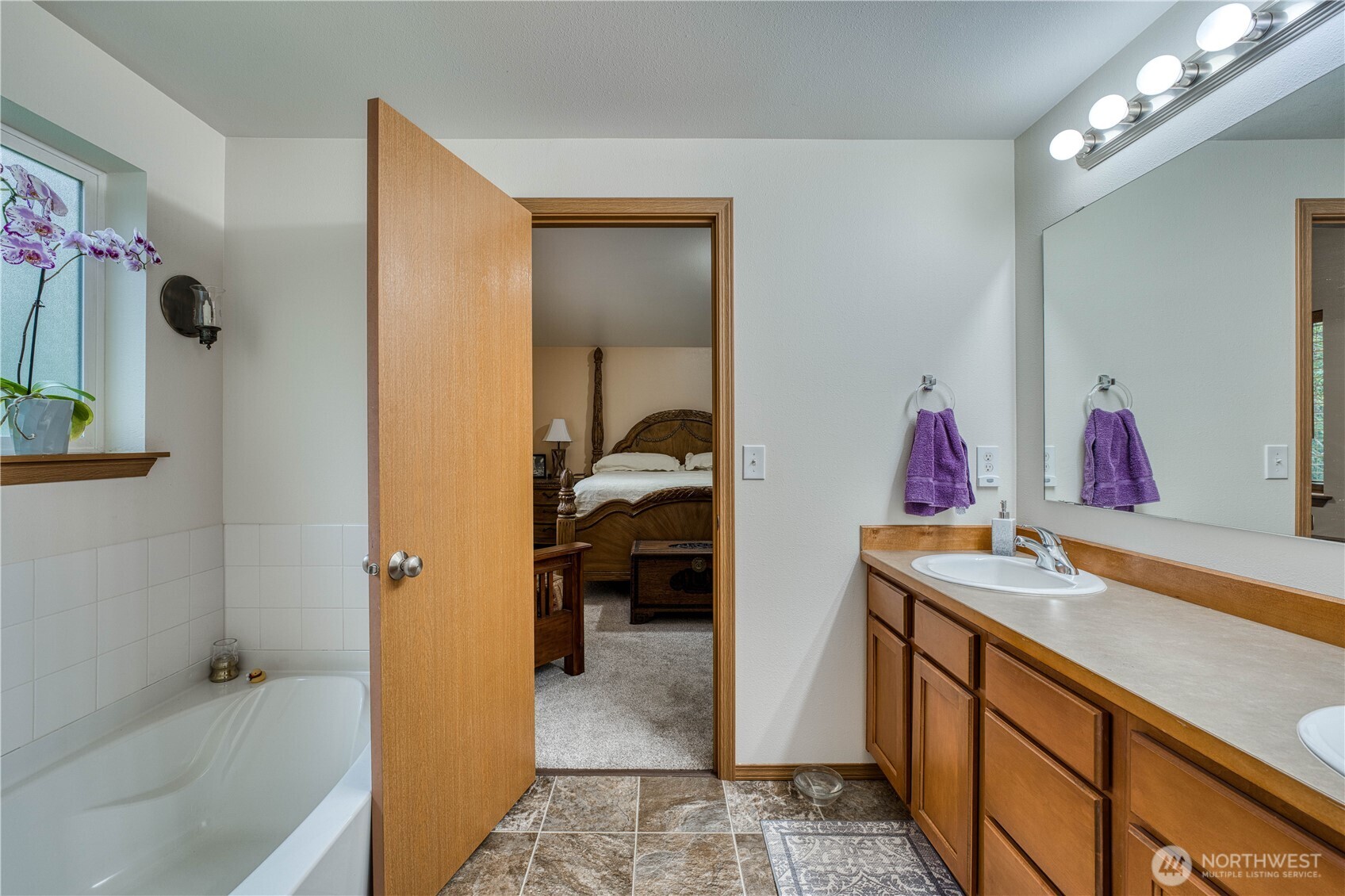 991 Northeast Hurd Road Belfair, WA 98528 - Photo 34 of 40 a en suite bathroom with a sink and a mirror
