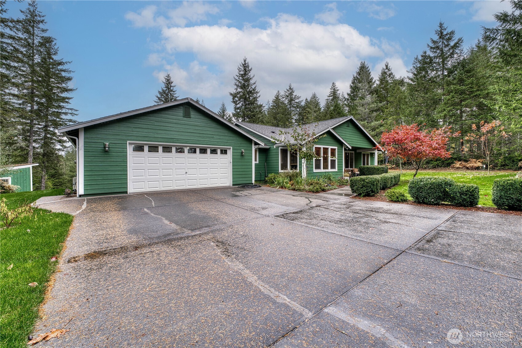 991 Northeast Hurd Road Belfair, WA 98528 - Photo 4 of 40 a front view of a house with a yard and garage