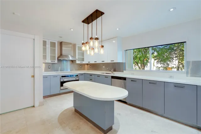 a kitchen with a sink cabinets and window