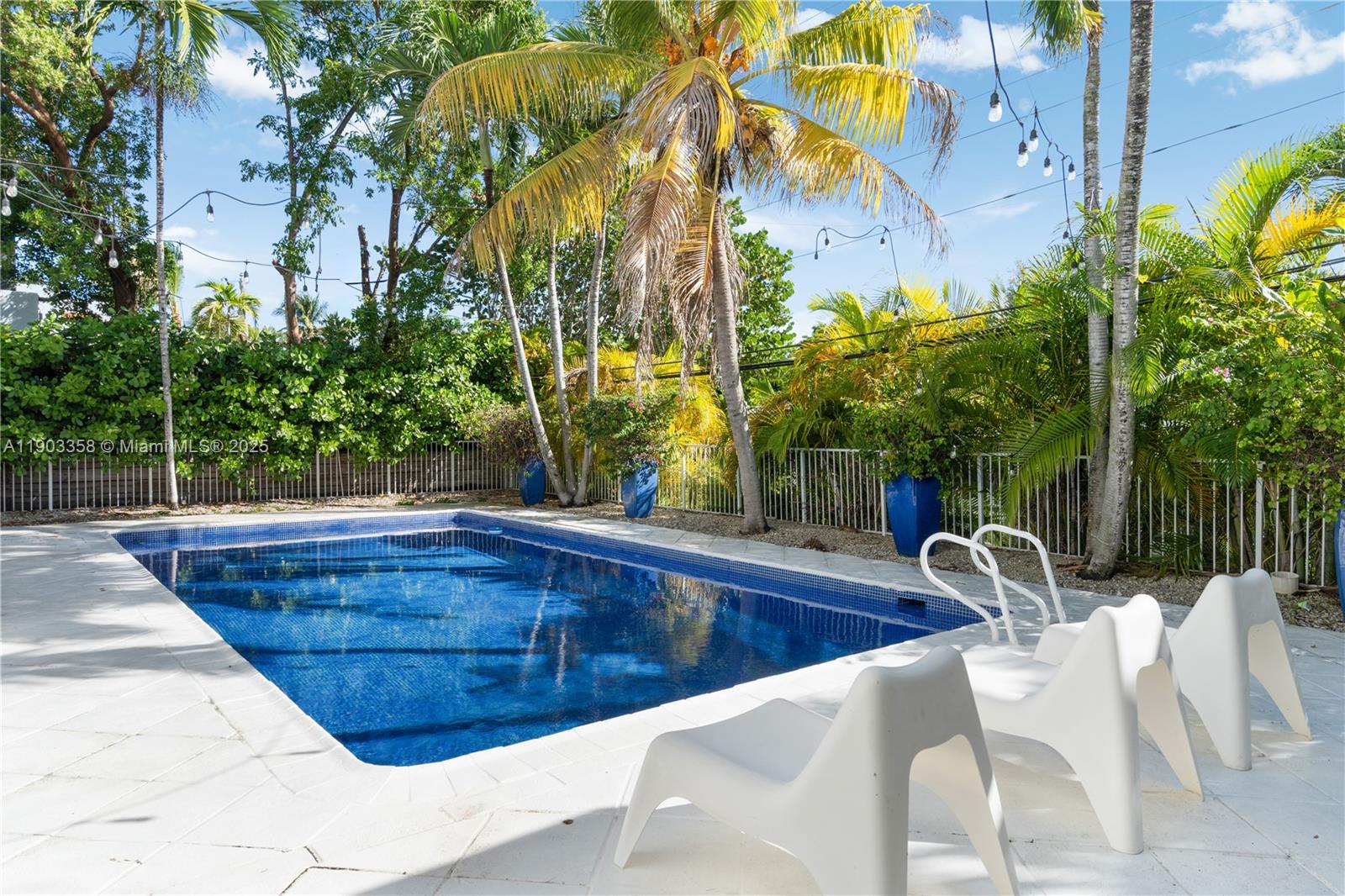 525 Ridgewood Road Key Biscayne, FL 33149 - Photo 17 of 62 a view of a swimming pool with a patio