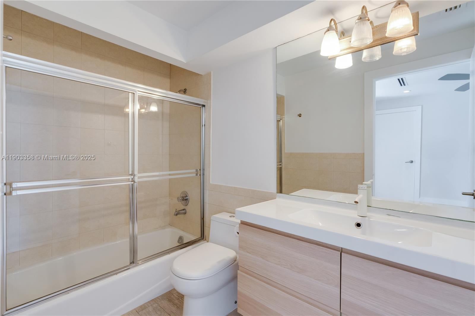 525 Ridgewood Road Key Biscayne, FL 33149 - Photo 21 of 62 a bathroom with a sink a toilet and shower