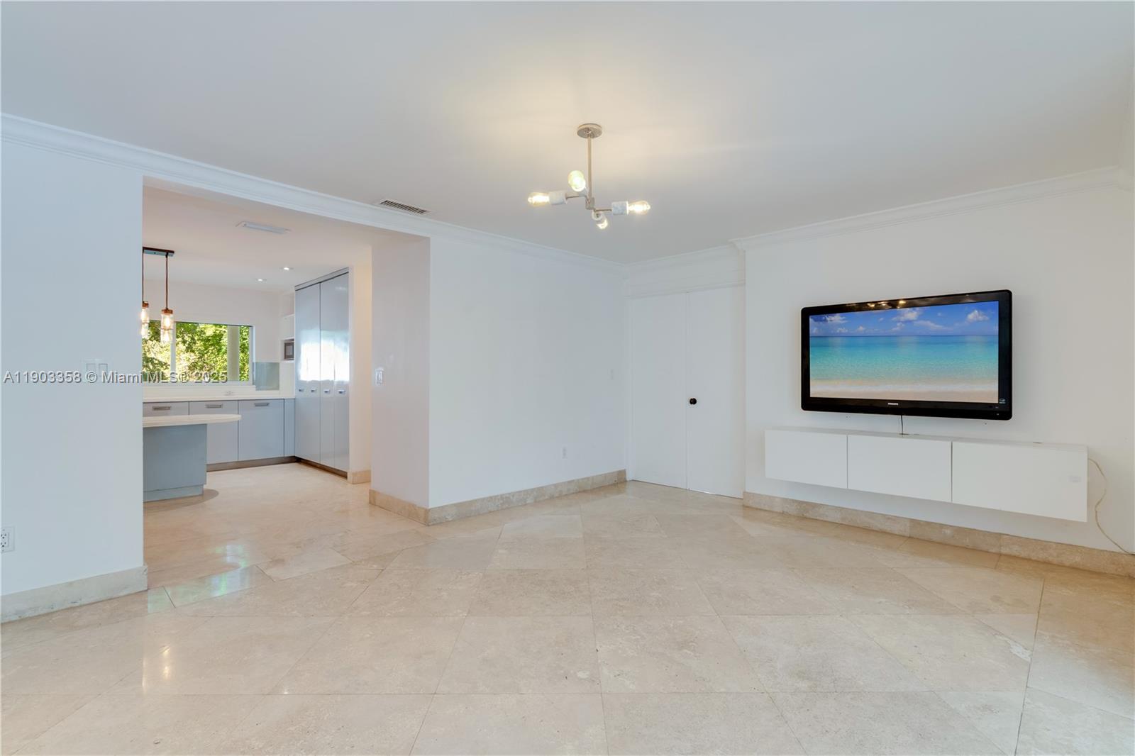 525 Ridgewood Road Key Biscayne, FL 33149 - Photo 38 of 62 an empty room with windows and ceiling fan
