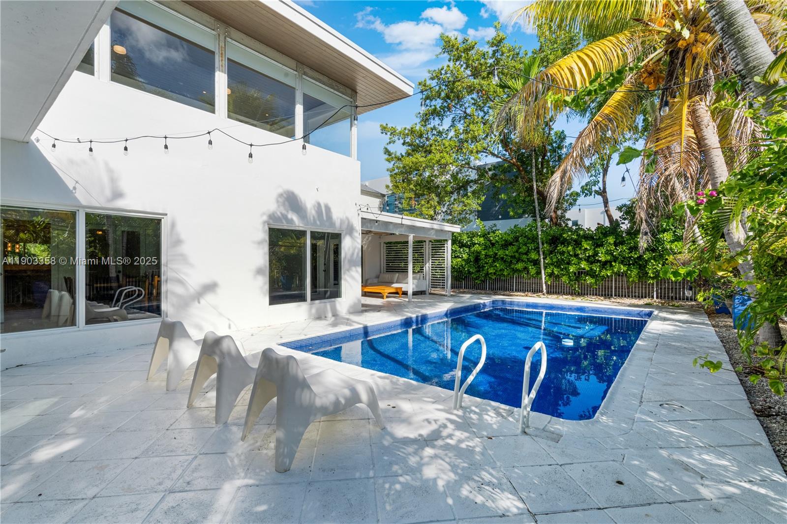 525 Ridgewood Road Key Biscayne, FL 33149 - Photo 51 of 62 a view of a house with backyard and sitting area