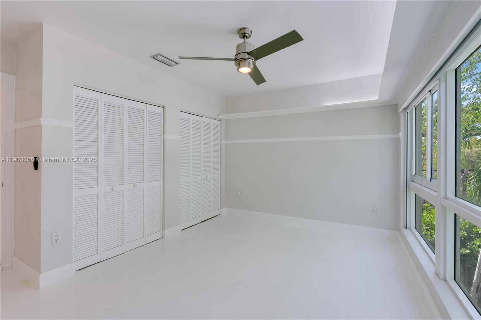 525 Ridgewood Road Key Biscayne, FL 33149 - Photo 9 of 62 a view of an empty room with a window