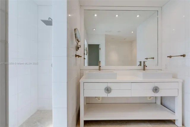 a bathroom with a sink mirror and vanity