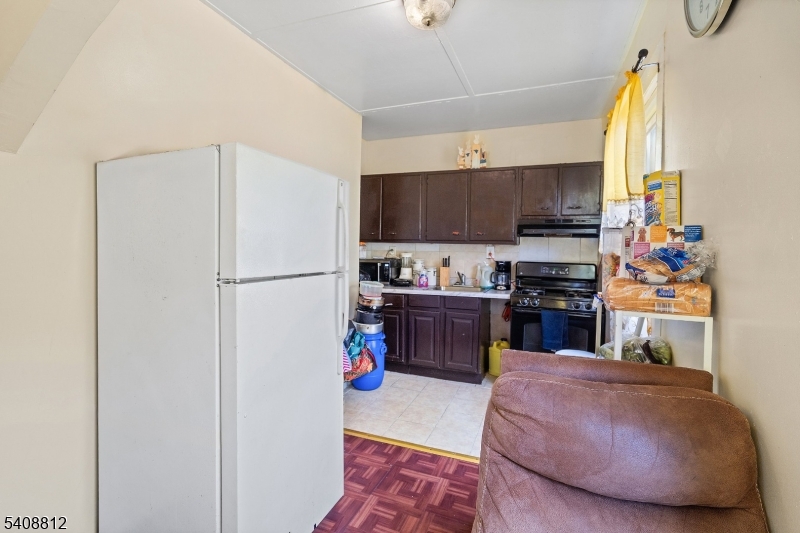 11 Mercer Street Paterson, NJ 07524 - Photo 3 of 10 a kitchen with stainless steel appliances a refrigerator sink and cabinets