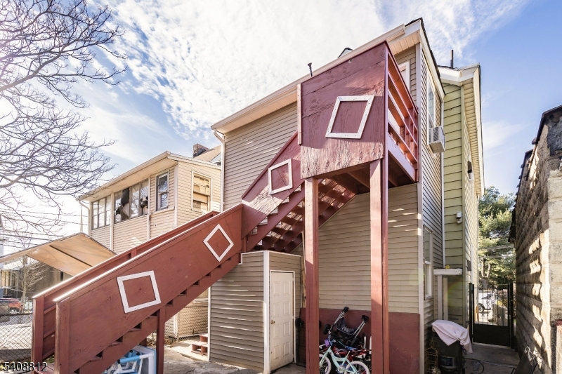 11 Mercer Street Paterson, NJ 07524 - Photo 5 of 10 a front view of a house with a tree