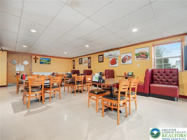 a living room with furniture a rug and white walls