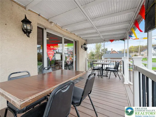 a outdoor dining space with furniture and outdoor view