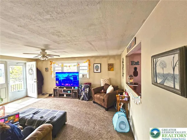 a kitchen with stainless steel appliances kitchen island granite countertop a refrigerator oven a sink dishwasher and white cabinets with wooden floor