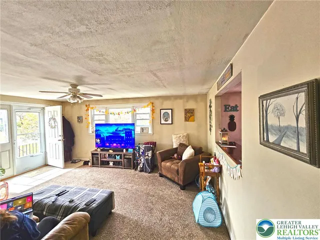 a kitchen with stainless steel appliances kitchen island granite countertop a refrigerator oven a sink dishwasher and white cabinets with wooden floor