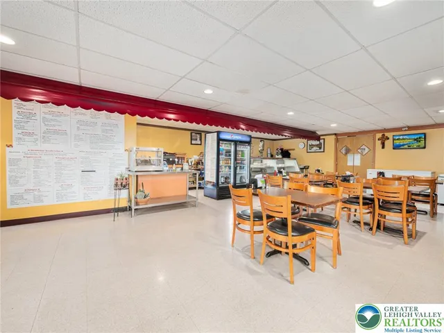 a living room with lots of furniture and a large window