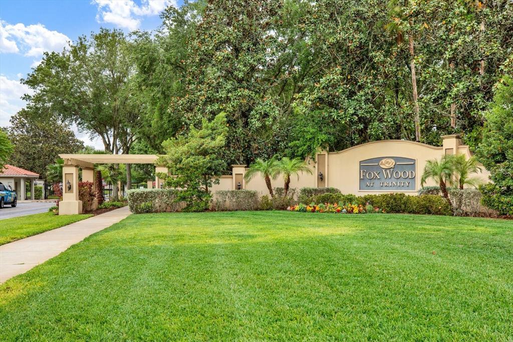 2021 Meadow Rue Court Trinity, FL 34655 - Photo 34 of 41 a view of a big yard with large trees and a barn