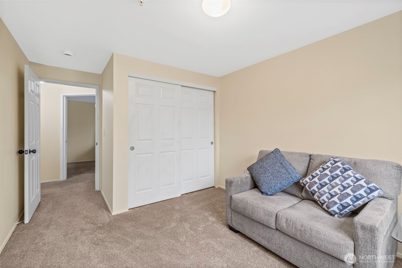 10824 Southeast 170th Street, Unit B103 Renton, WA 98055 - Photo 22 of 31 a living room with furniture and a walk in closet