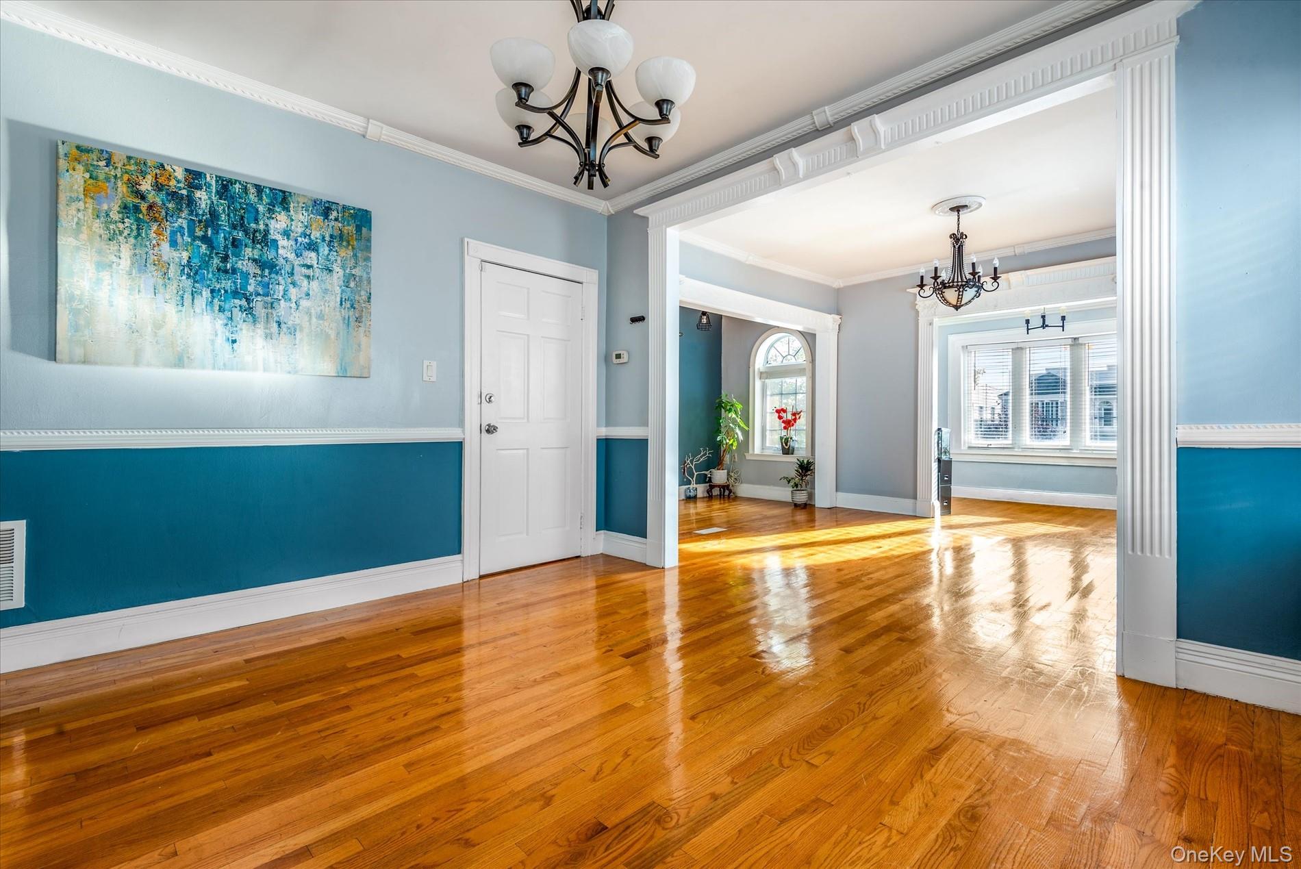 93-17 123rd Street Queens, NY 11419 - Photo 8 of 40 Unfurnished dining area featuring a chandelier, hardwood / wood-style floors, and crown molding