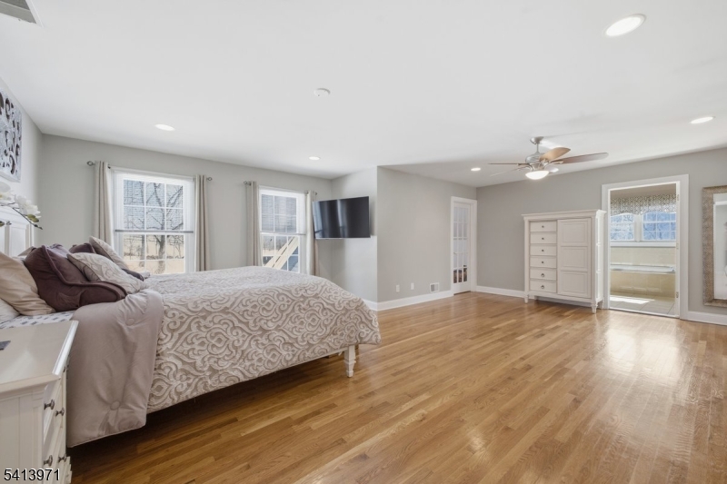 115 Mt Lebanon Road Glen Gardner, NJ 08826 - Photo 23 of 49 a spacious bedroom with a bed and a dresser with wooden floor