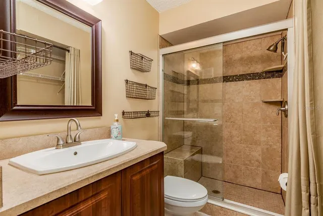 a bathroom with a sink toilet and shower