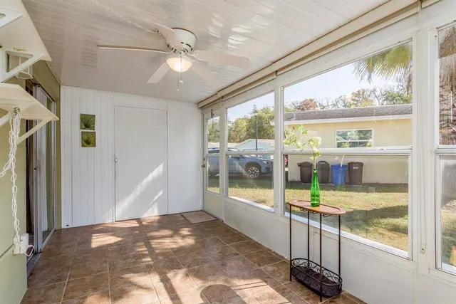 a view of water heater room with wooden floor and windows